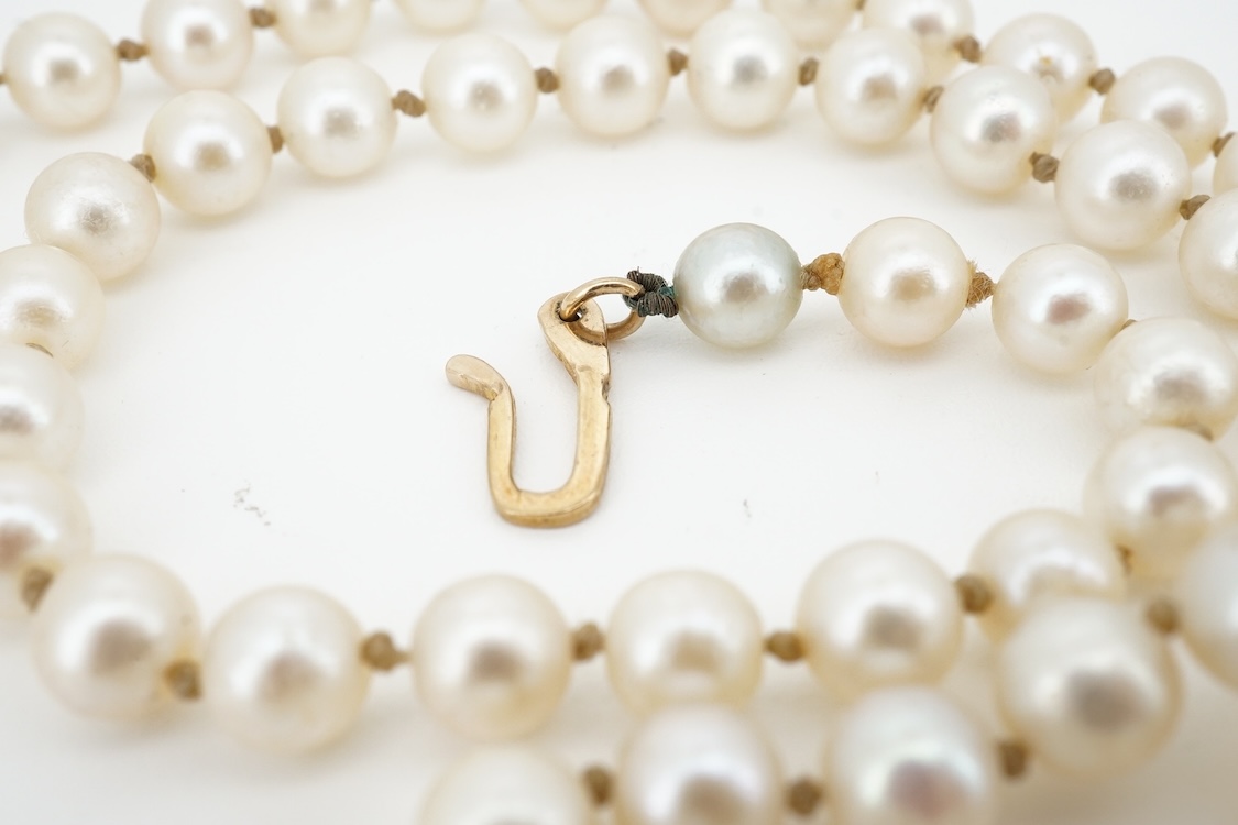 A cultured pearl and aquamarine necklace, composed of a single strand of cultured pearls, to a gold clasp set with an oval aquamarine, length 53.5cm, Condition: in good condition, minor wear, minor variations in pearl co